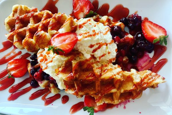 Waffles served with strawberries and cream at Lewis's Ice Cream Cafe
